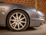 a car parked in a garage with a brick wall in the background