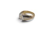 a close up of a gold ring with a diamond on it