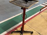an image of a table on a stand in a warehouse