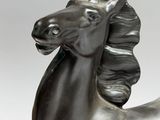 statue of a horse with a long mane on a white background