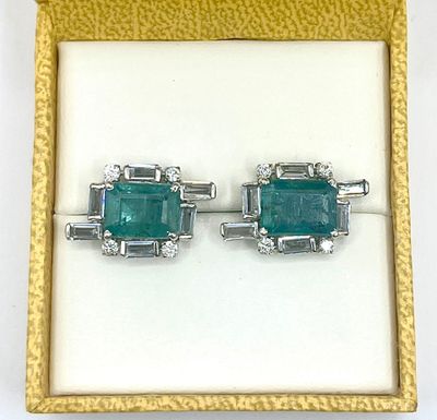 an image of a pair of emerald and diamond earrings in a box