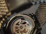 a watch that is sitting on a table with a chain around it
