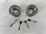 two silver spoons and two silver spoons on a white surface
