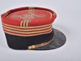 a red and black hat with gold trim on it