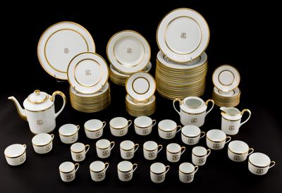 many cups and saucers that are sitting on a table