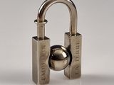a metal padlock with a ball attached to it
