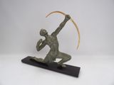 bronze sculpture of a man with a scythe on a black base