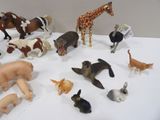 a lot of toy animals that are on a table