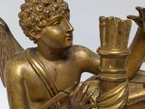 a gold clock with a statue of an angel holding a book