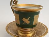 a cup and saucer on a saucer on a white table