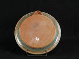 a brown and green plate with a tag on it