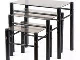 three glass tables with metal legs and a glass top