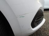 a close up of a car ' s front bumper with scratches on it