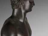 a bronze statue of a man holding a vase in his hand