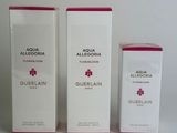 three boxes of perfume sitting next to each other on a white surface