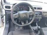 dashboard of a small car with a steering wheel and dashboard controls