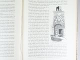 an open book with a drawing of a clock on the front of it