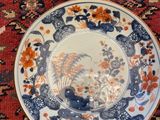 a blue and white plate sitting on top of a red rug