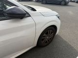 a white car parked in a parking lot with other cars in the background
