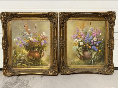 two paintings of vases with flowers in them on a wall