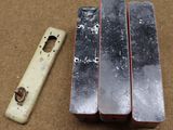 three pieces of metal sitting next to each other on a table