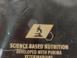 a person holding a sign that says science based nutrition developed with purina