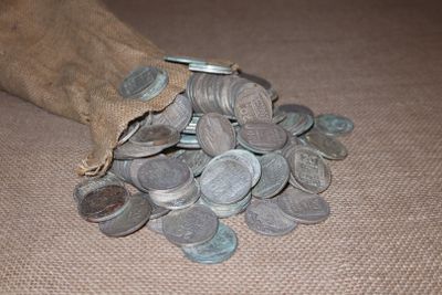a bag full of coins sitting on a table