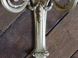 a wall sconce on the floor with a clock on it