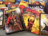 a lot of comic books sitting on a table