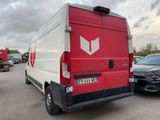 a red and white van that is parked in a parking lot