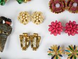 many different types of jewelry on a white surface