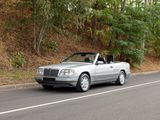 a silver car that is driving down the road