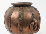 a bronze vase with a handle on a white background