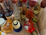 many bottles of alcohol sitting on a table