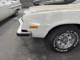a white car parked in a parking lot with other cars in the background