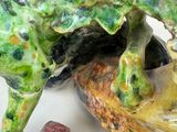 a close up of a figurine of a fish on a plate