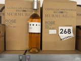 many boxes of wine on a shelf in a store