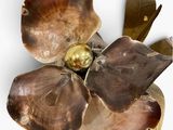 a close up of a flower brooch on a white surface