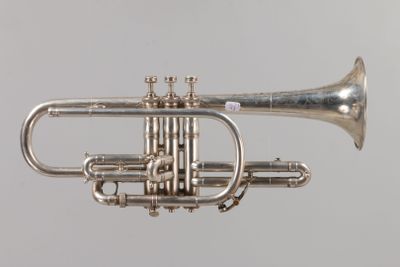 a silver trumpet that is sitting on a table