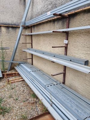 a row of empty metal shelves on the side of a building