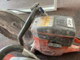 a chainsaw sitting on the floor next to a pair of shoes