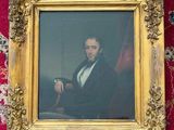 painting of a man in a suit and tie sitting in a gold frame on a red carpet