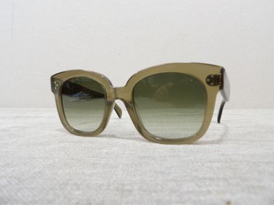 sunglasses on a white surface with a white wall in the background