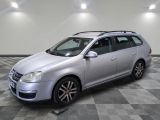 the silver volkswagen golf wagon is parked on a checkered floor