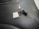 a car key sitting on top of a black leather seat