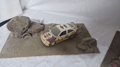 a toy car that is sitting on top of a piece of paper