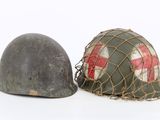 two helmets are sitting next to each other on a white surface