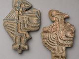 two ancient clay figurines of a man and a woman