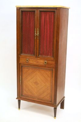 an old wooden cabinet with a red curtain on top of it