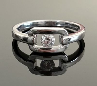 an image of a diamond ring on a reflective surface